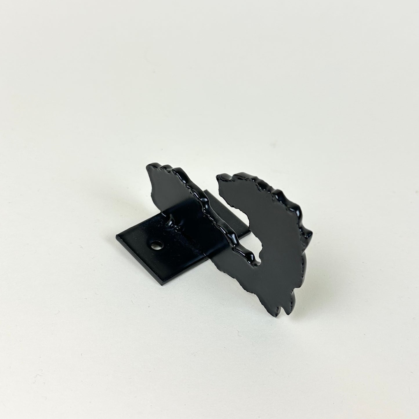 Black metal wall hook by Lisa Reiser