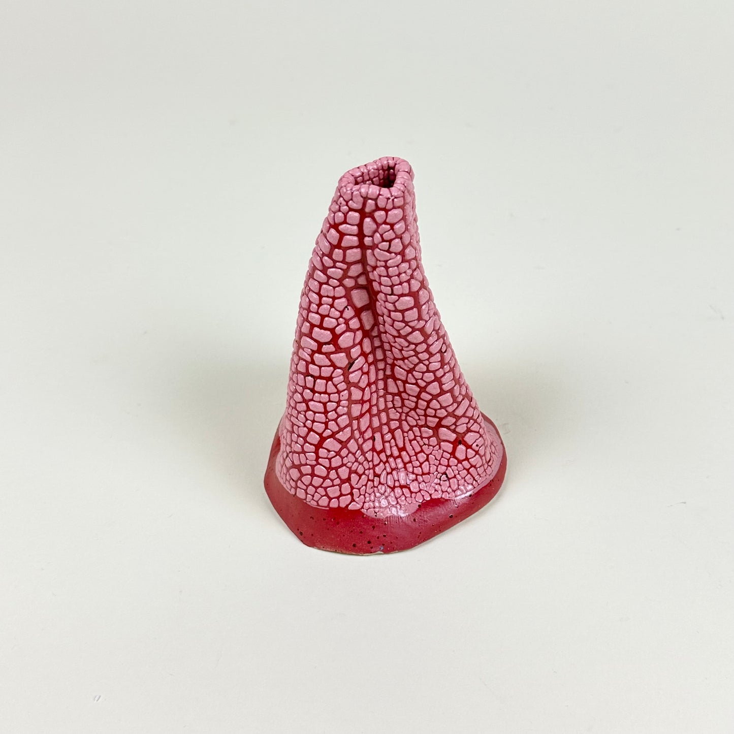 Red and pink volcano vase (L) by Astrid Öhman.
