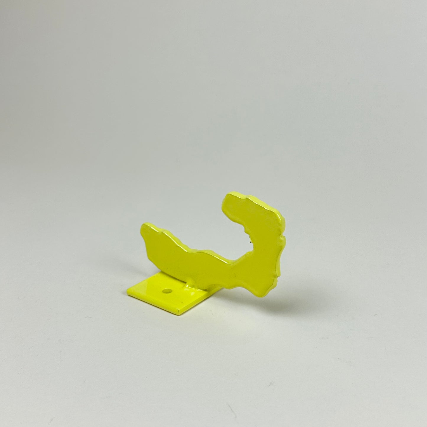 Yellow metal wall hook by Lisa Reiser