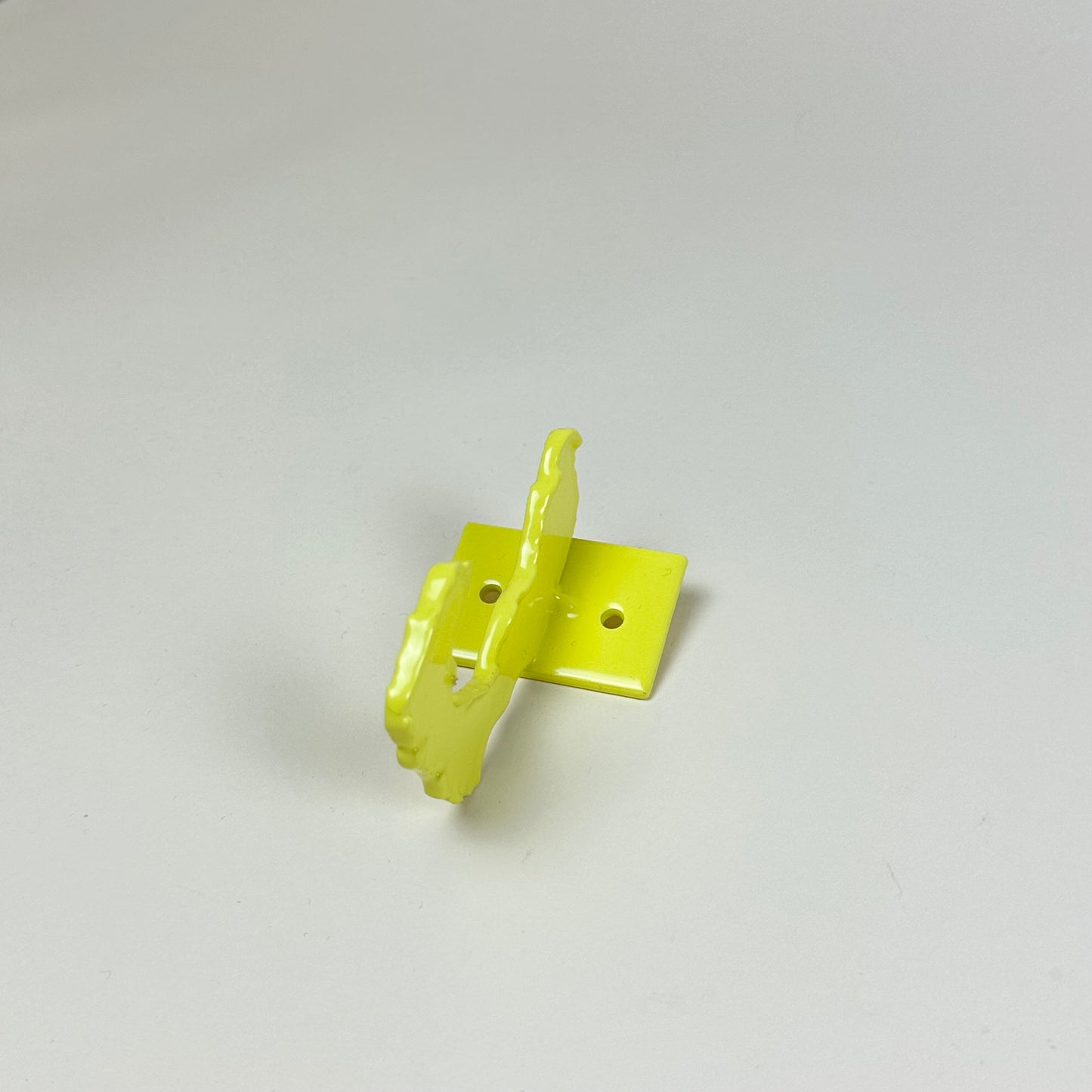 Yellow metal wall hook by Lisa Reiser