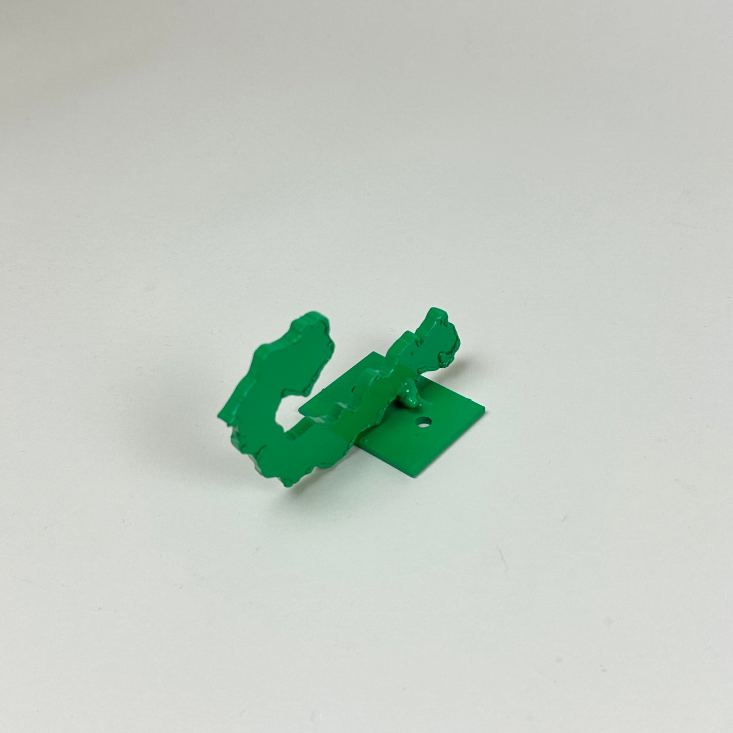 Green metal wall hook by Lisa Reiser