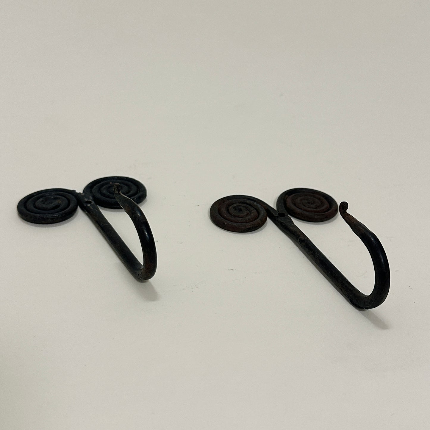 Pair of black metal wall hooks, vintage