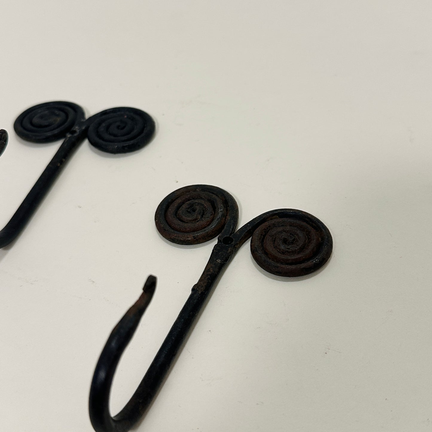 Pair of black metal wall hooks, vintage