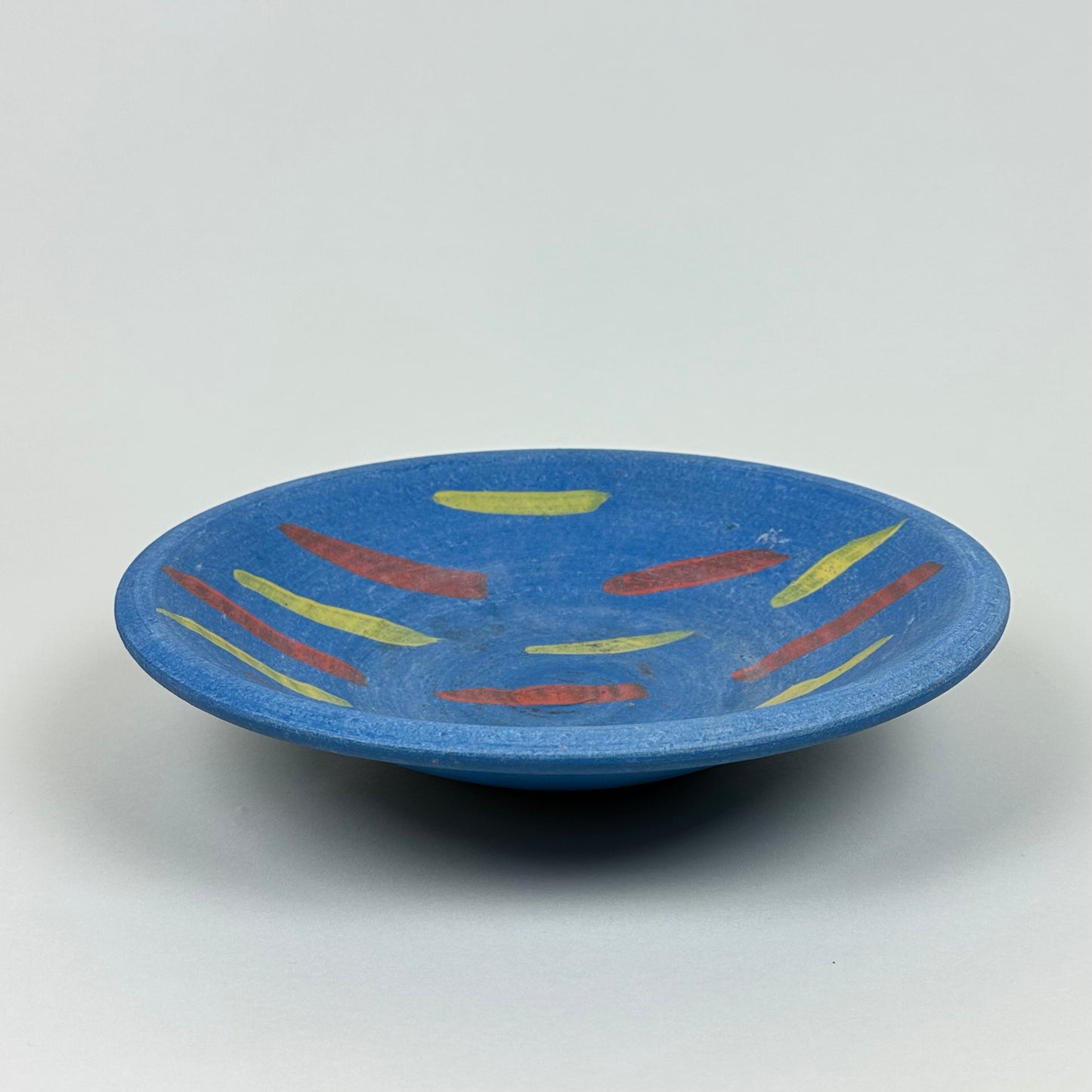 Blue ceramic bowl with red and yellow decor, vintage