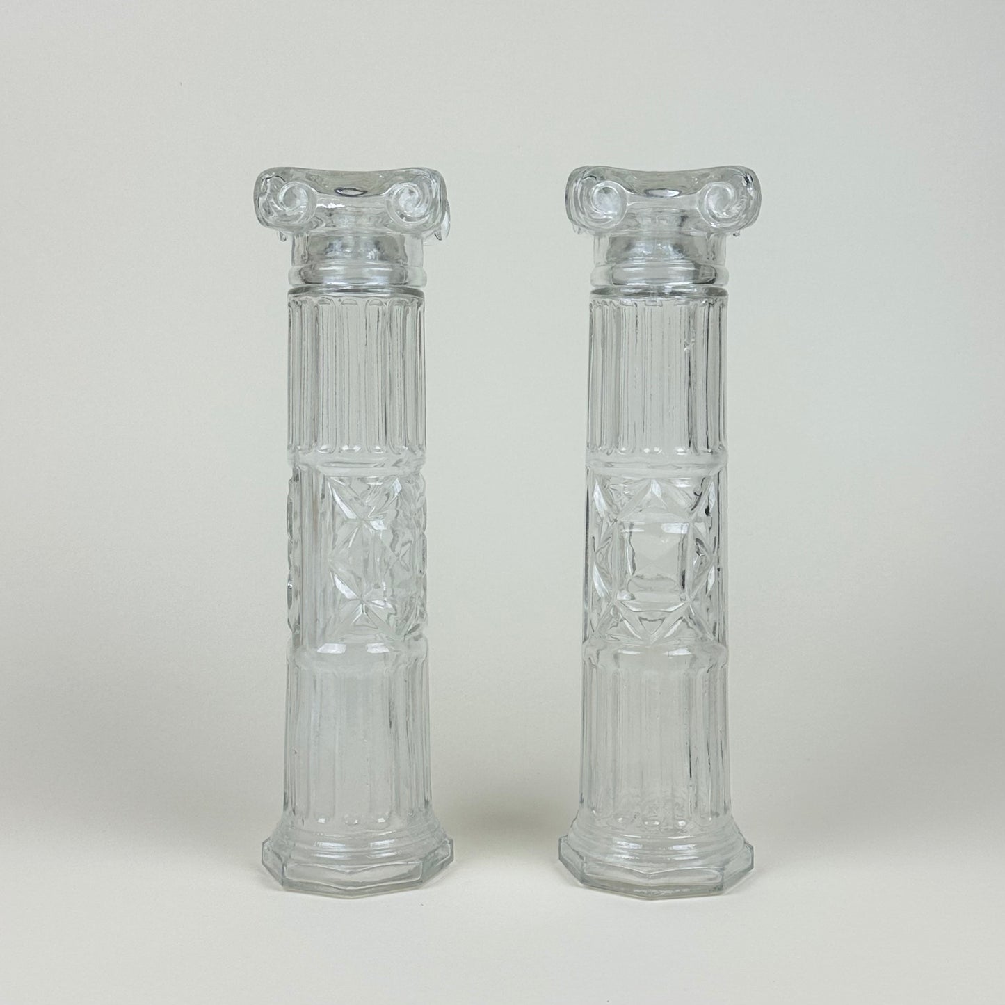 Glass bottles shaped like Roman pillars, pair