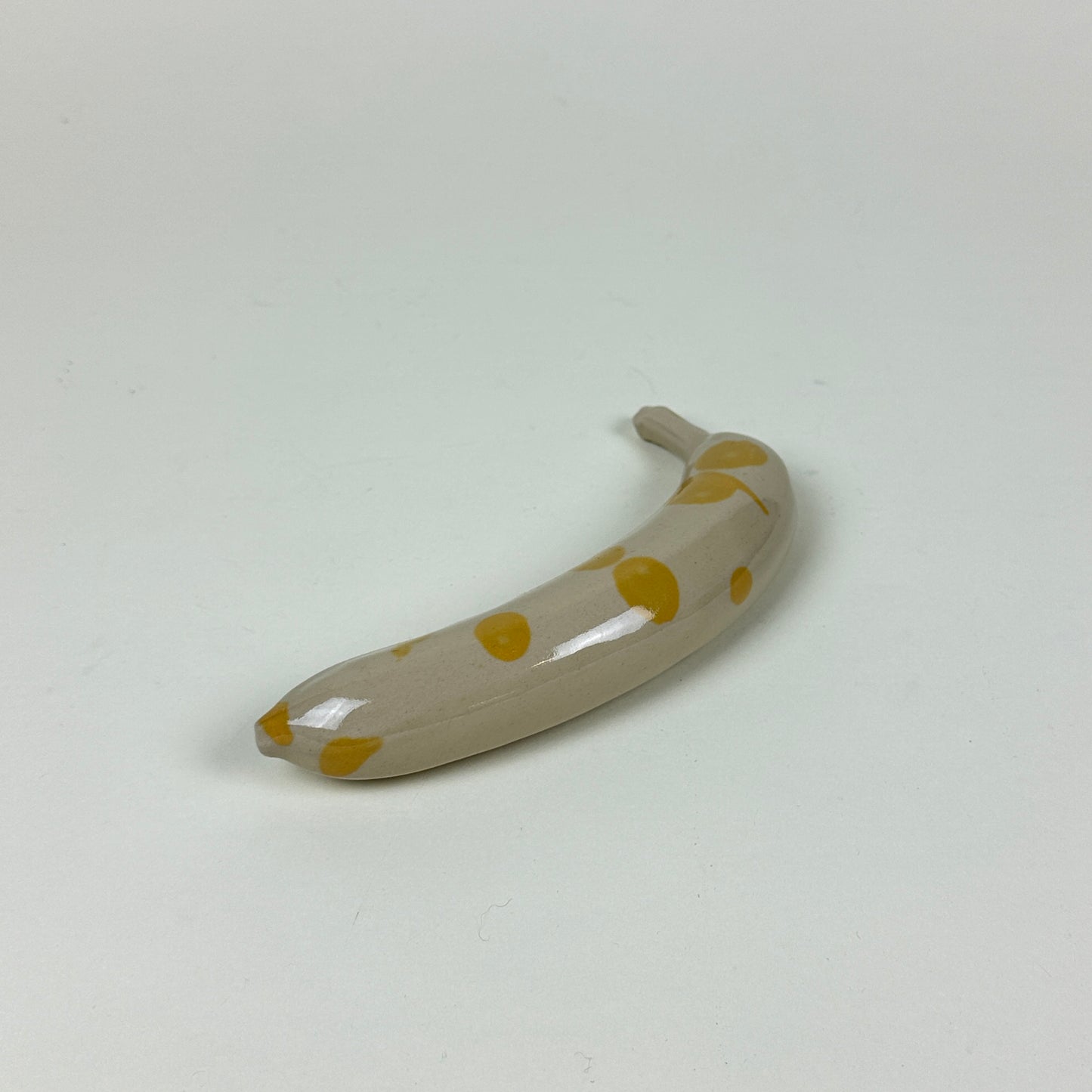 Yellow spotted stoneware banana by Malwina Kleparska
