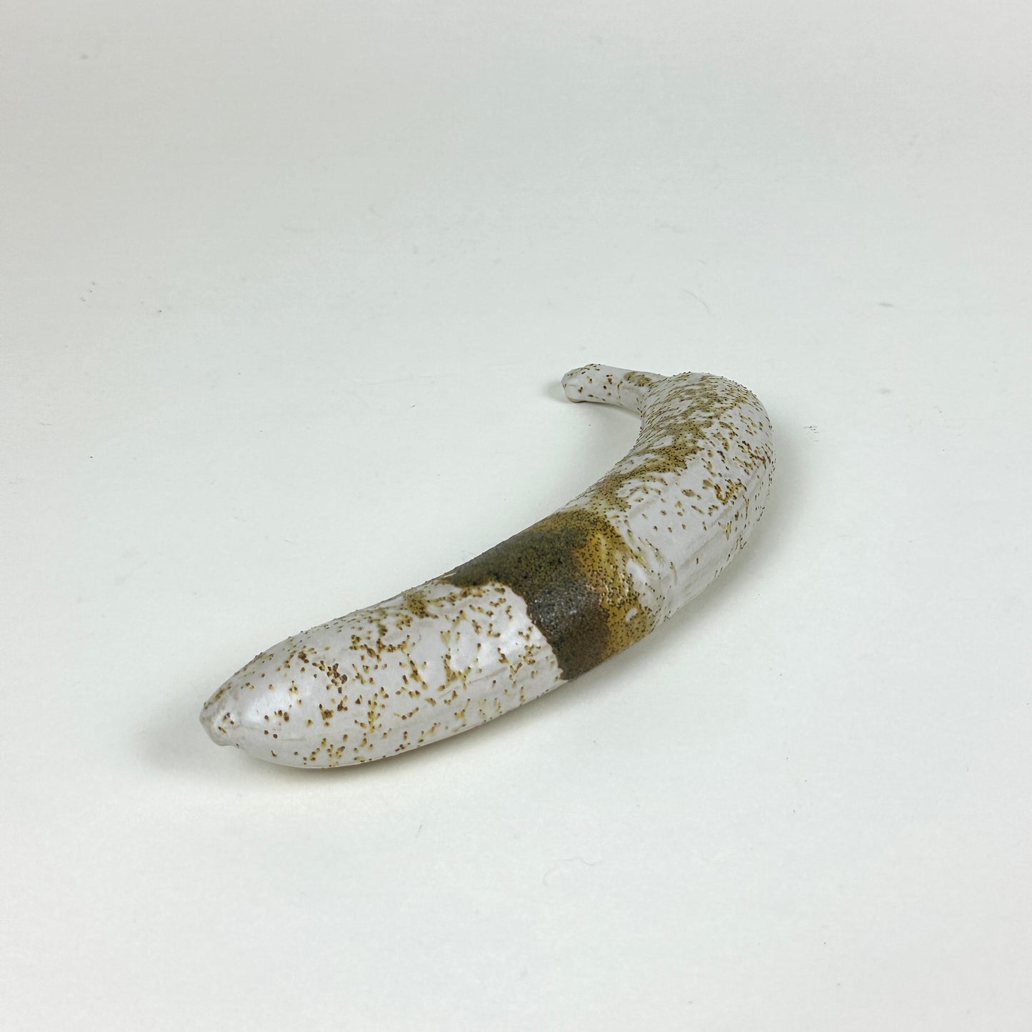 Yellow/brown stained stoneware banana by Malwina Kleparska