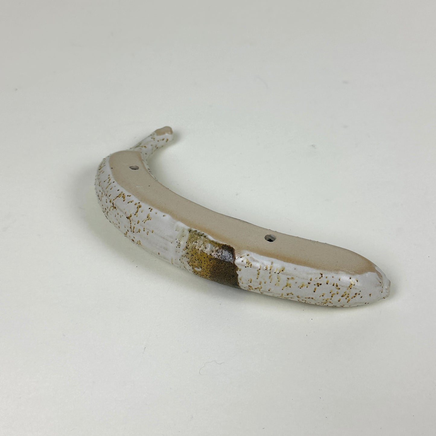 Yellow/brown stained stoneware banana by Malwina Kleparska