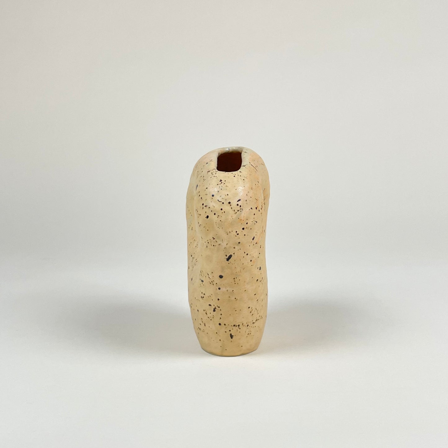 Orange ceramic vase with black speckles by Malwina Kleparska