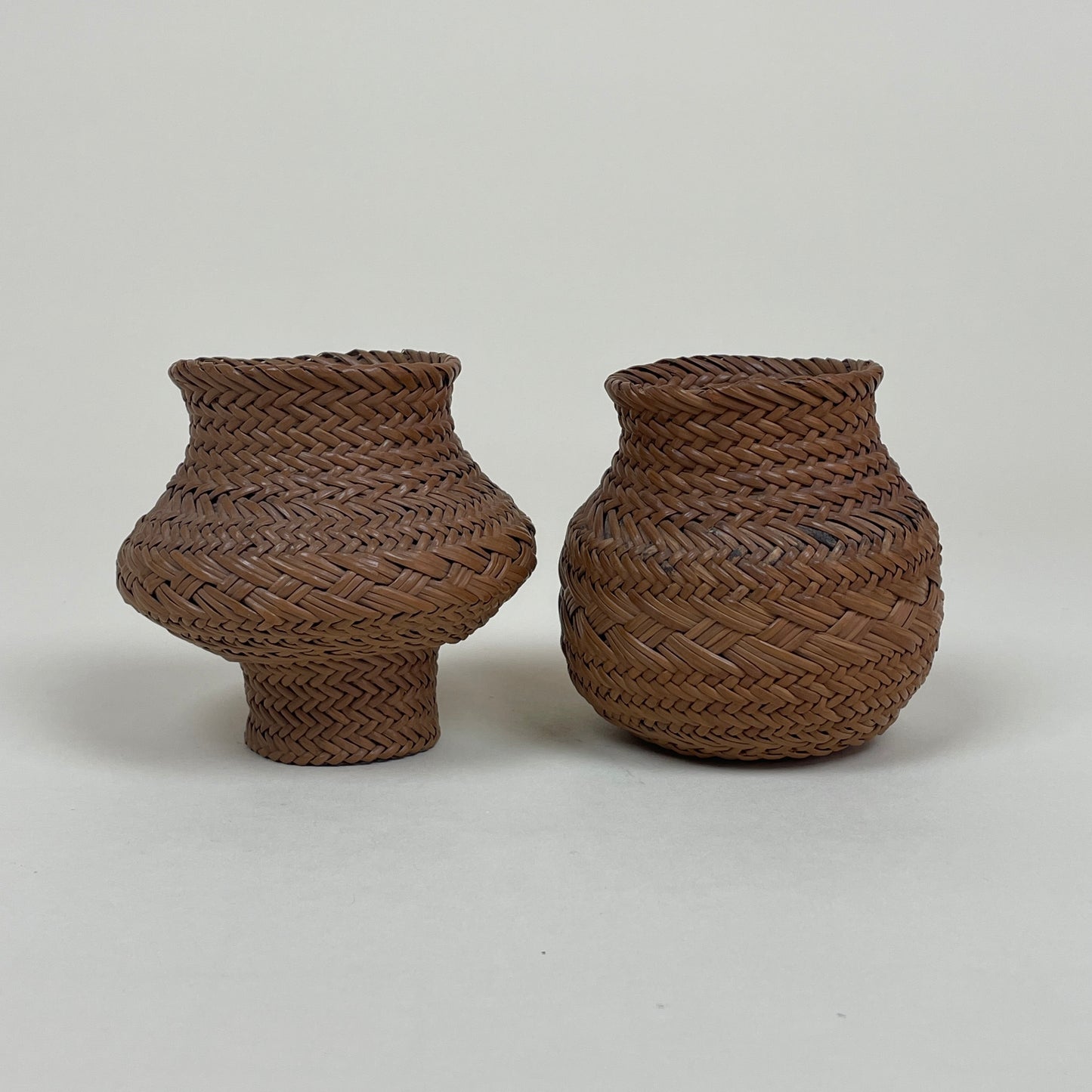Vintage pair of miniature rattan baskets