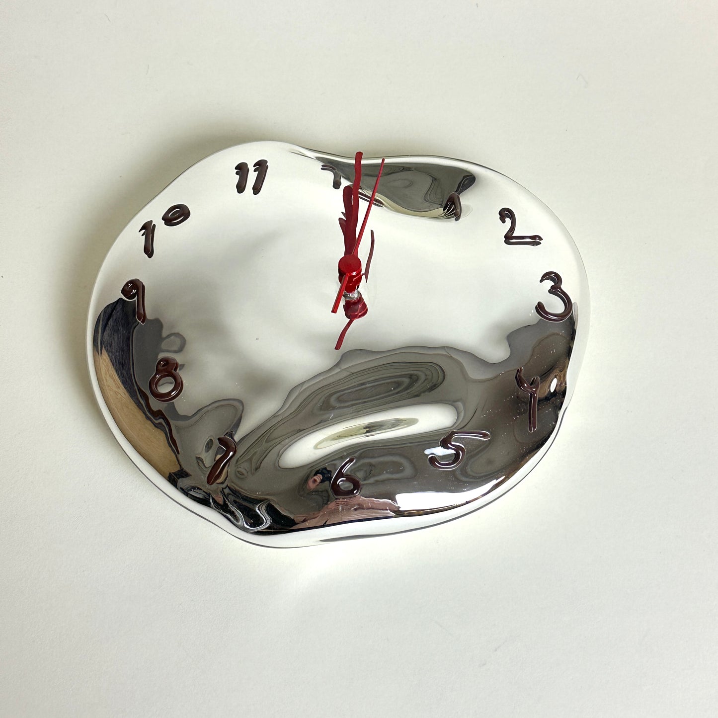 Silvered glass clock by Silje Lindrup