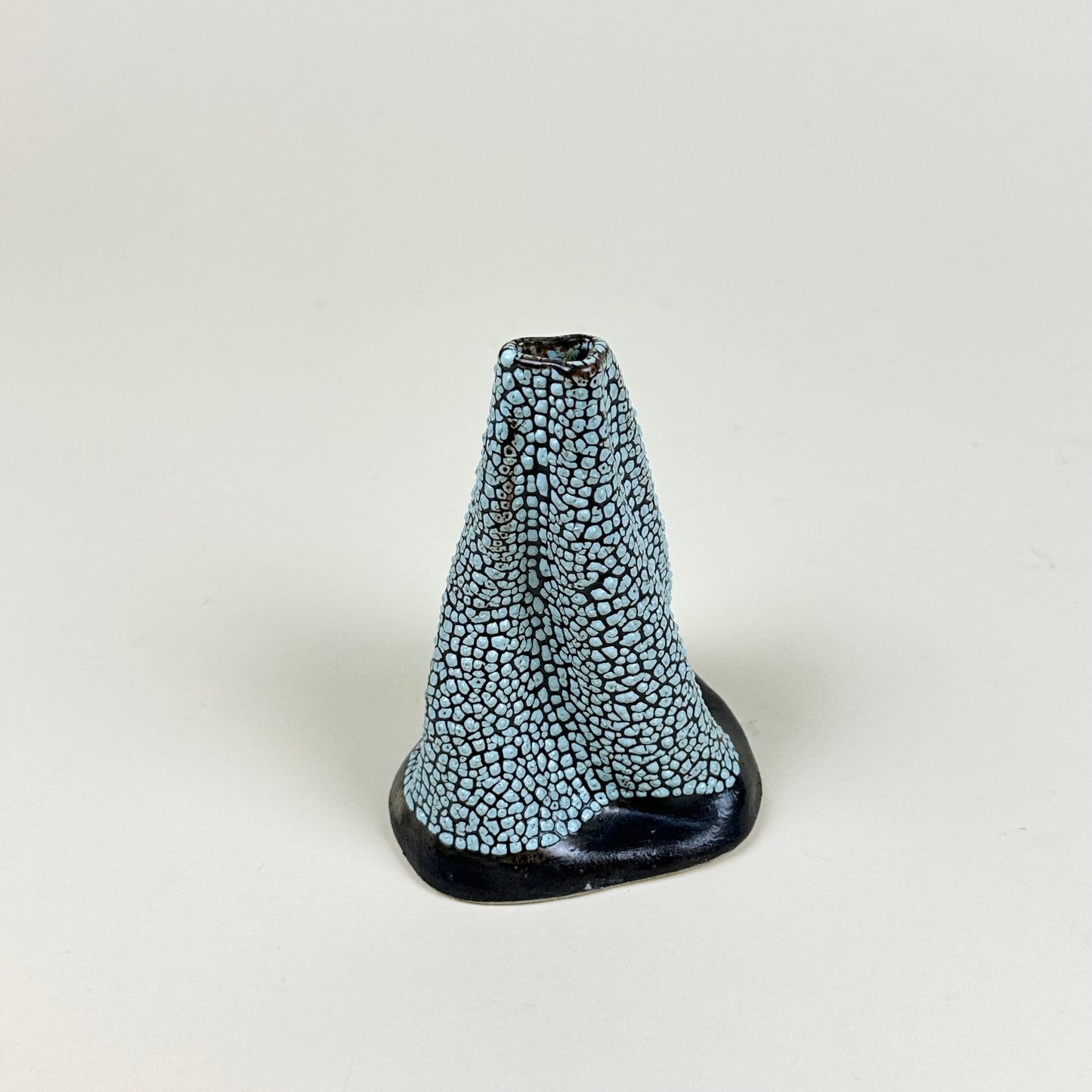 Black and light blue volcano vase (L) by Astrid Öhman.