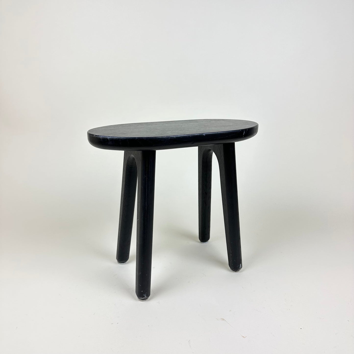 Small black 4 legged stool, vintage