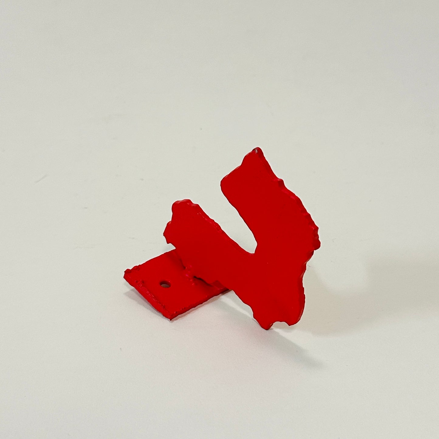 Red metal wall hook by Lisa Reiser