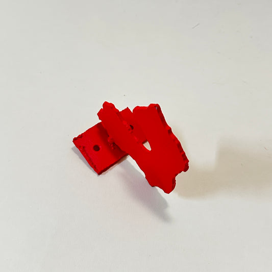 Red metal wall hook by Lisa Reiser