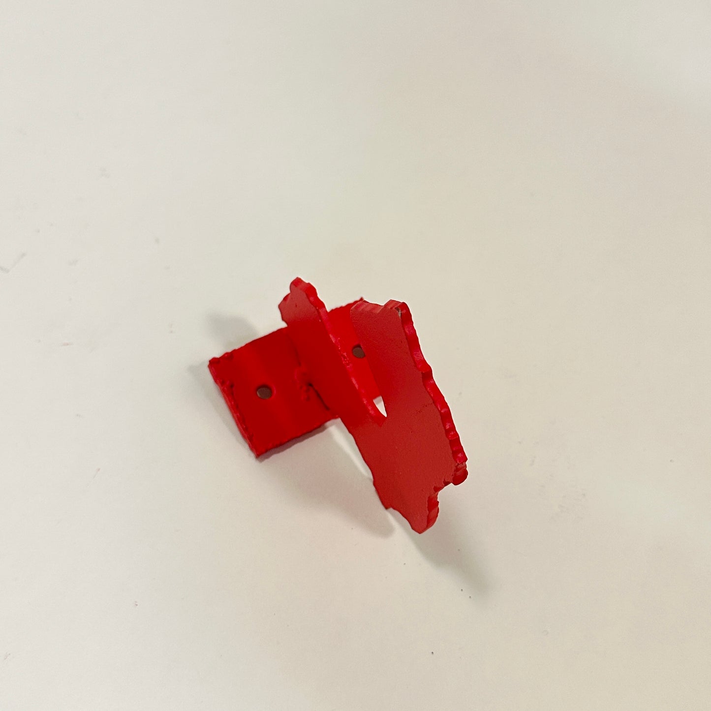 Red metal wall hook by Lisa Reiser