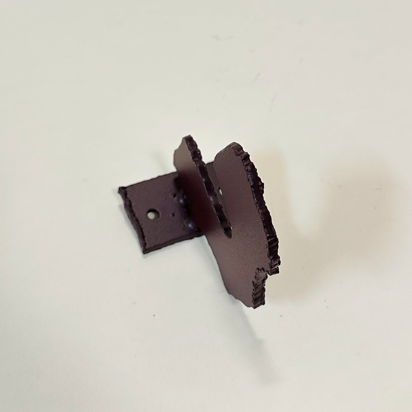 Brown metal wall hook by Lisa Reiser