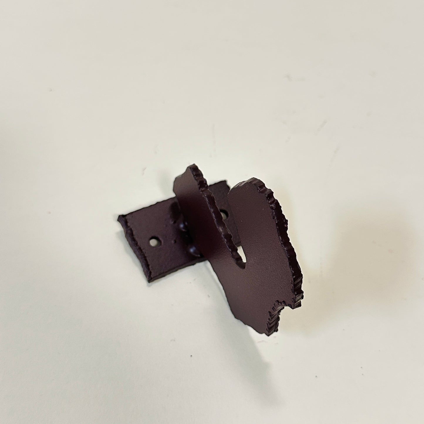 Brown metal wall hook by Lisa Reiser