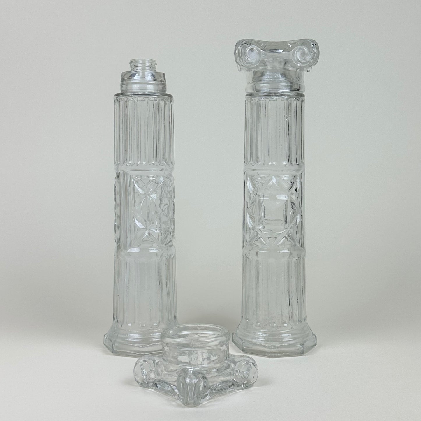 Glass bottles shaped like Roman pillars, pair