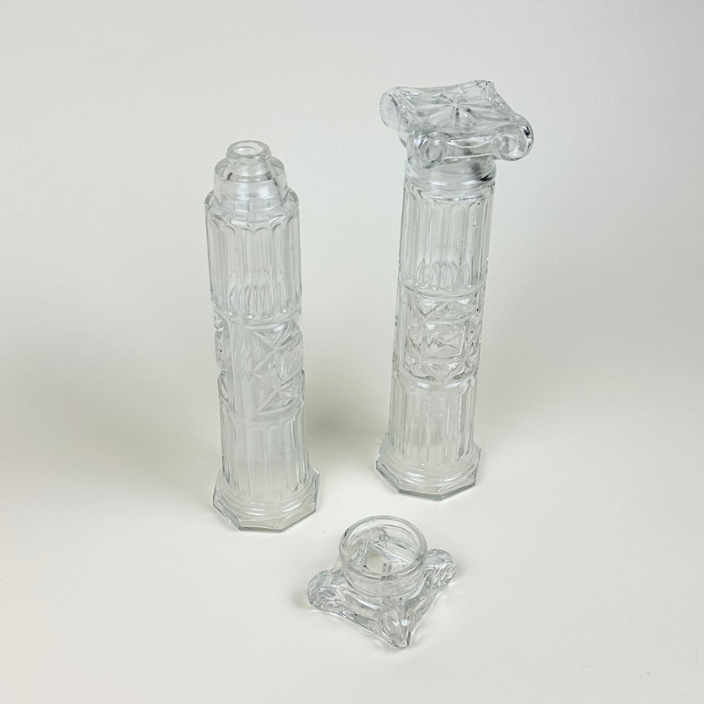 Glass bottles shaped like Roman pillars, pair