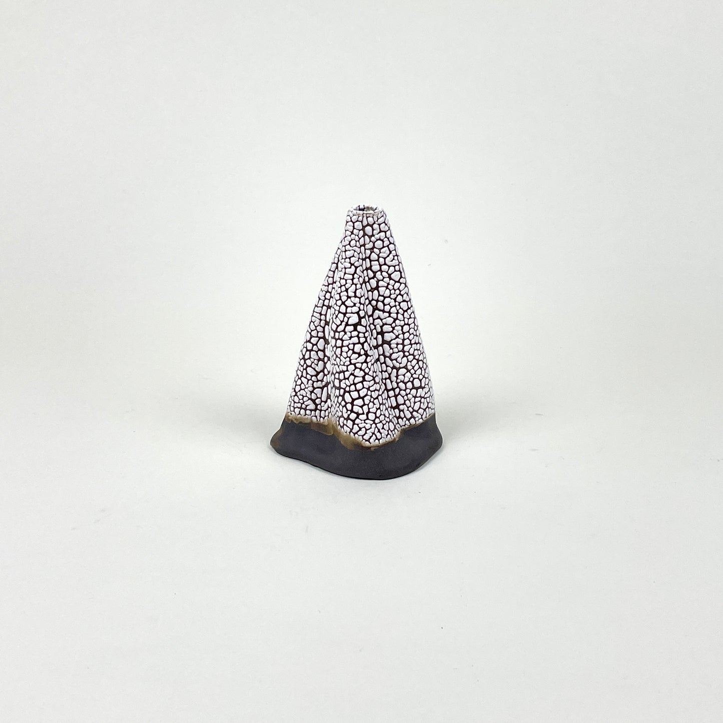 Dark brown and white volcano vase (L) by Astrid Öhman.