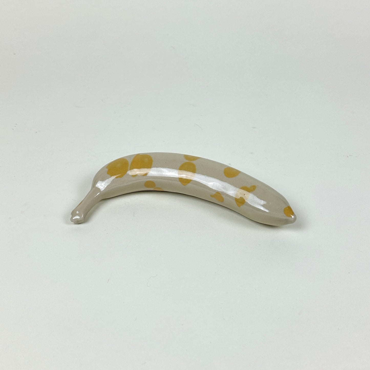 Yellow spotted stoneware banana by Malwina Kleparska