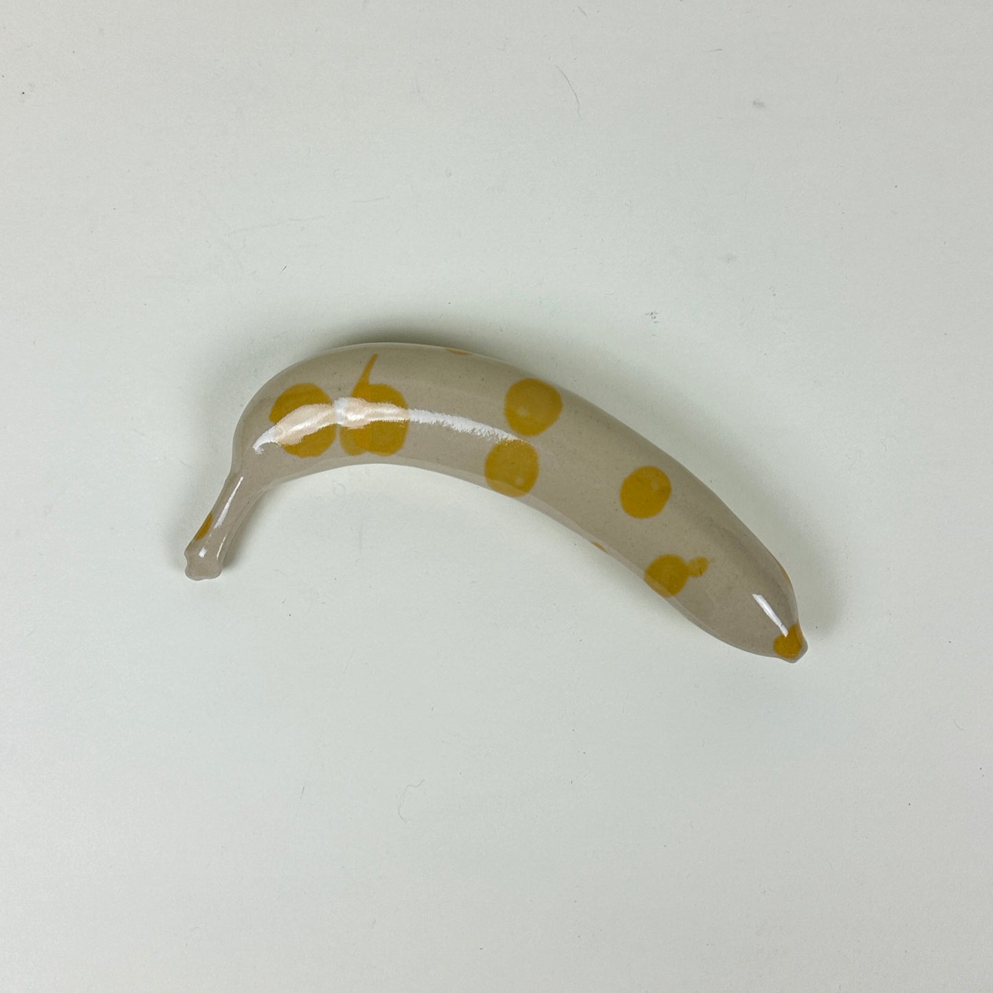 Yellow spotted stoneware banana by Malwina Kleparska