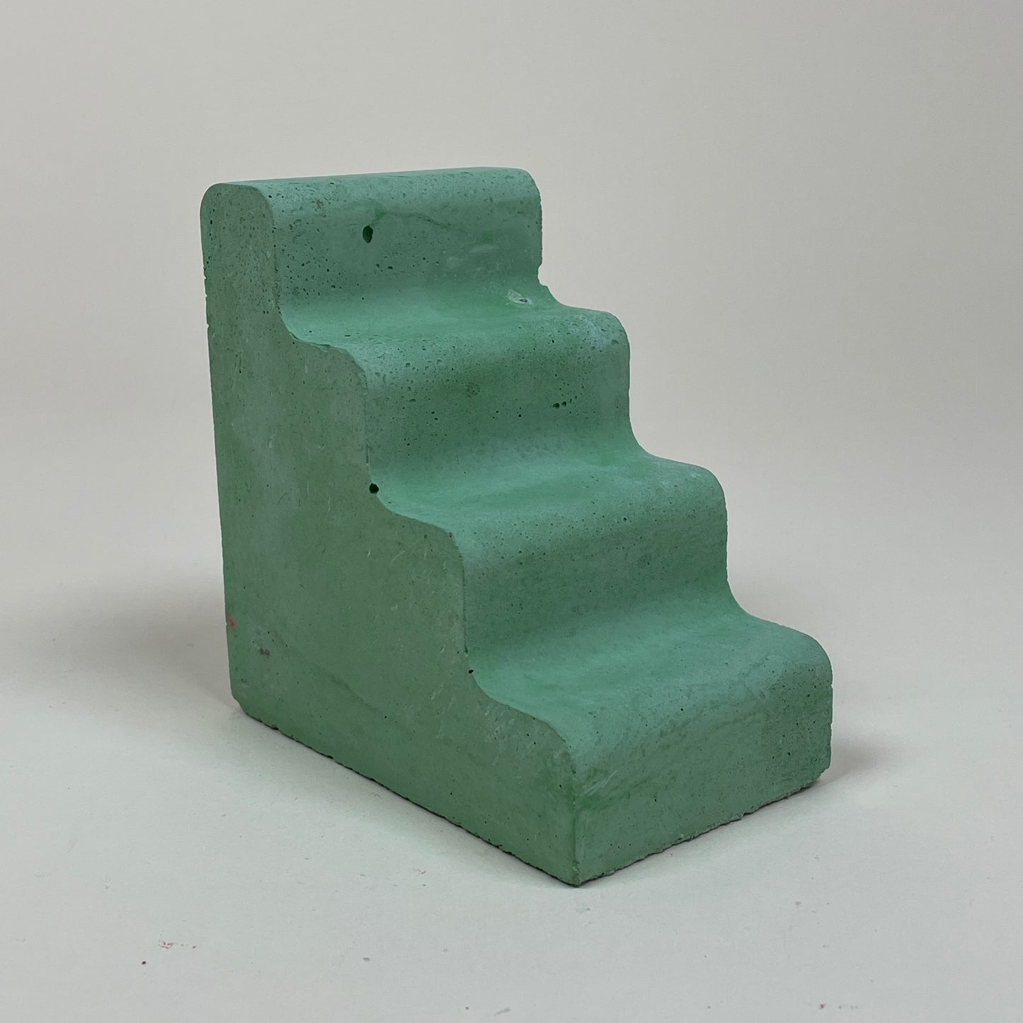 Green concrete bookend by Clara von Zweigbergk