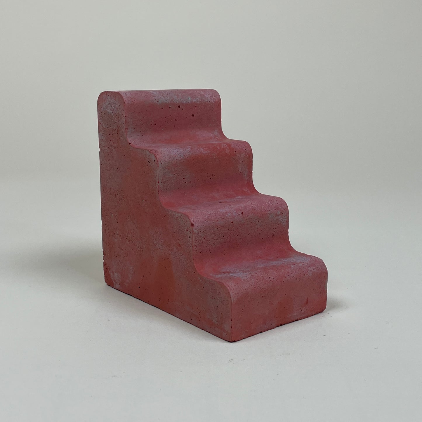 Red concrete bookend by Clara von Zweigbergk