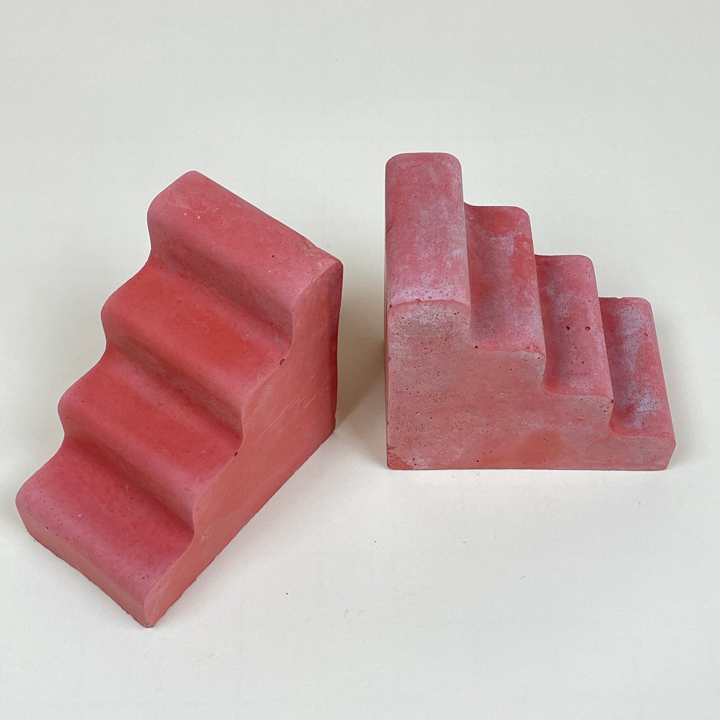 Pair of red concrete bookends by Clara von Zweigbergk