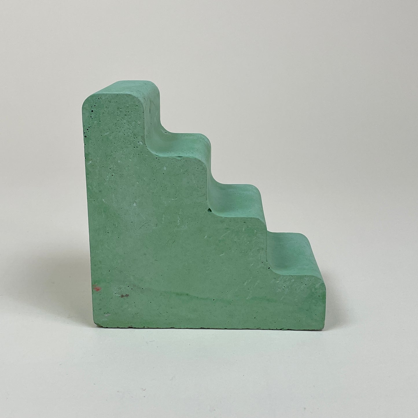 Green concrete bookend by Clara von Zweigbergk
